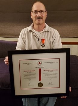 Daniel Chicoine with his Order of the Red Cross award