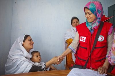 A Red Crescent worker and patient at a maternal health clinic in Pakistan
