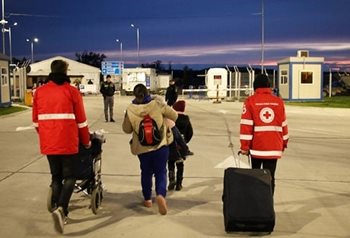Romanian Red Cross team members assist refugees from Ukraine at the border