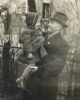 A black and white photo of a man holding a young girl