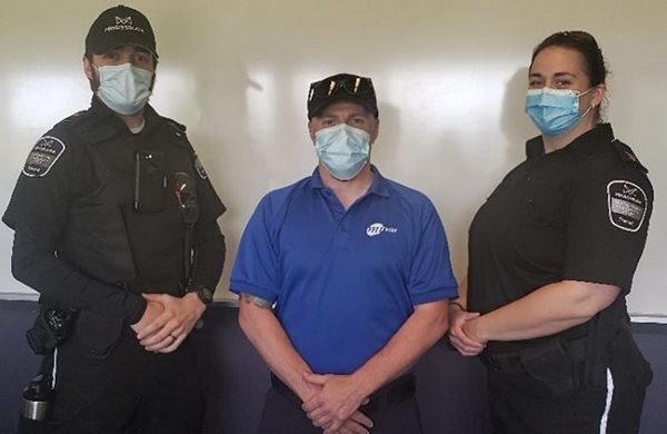 Three people in uniforms and masks