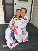 woman wrapped in blanket hugging son