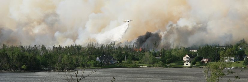 A large wild fire in a heavily forested community