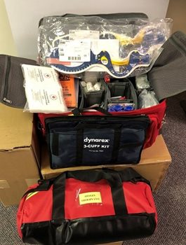 A large bag opened to display contents of first aid supplies to help in emergency response