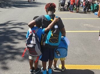Three young students with new backpacks