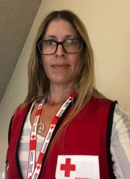 A woman in glasses and in a Canadian Red Cross vest