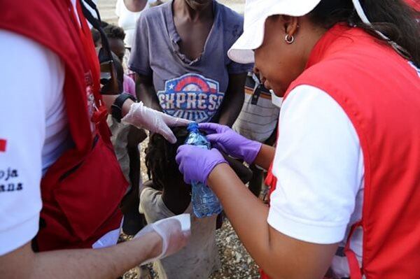 Haitian Red Cross staff Chantal Pitaud and Mexican Red Cross delegate Raziel Urunga cleaning eight-y