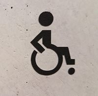 A symbol of person in a wheelchair