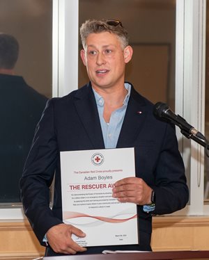 Adam Boyles holding is rescuer award