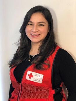 Denisse pictured smiling in her Canadian Red Cross vest