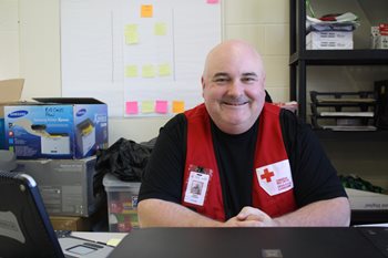 Volunteer Jason behind his desk