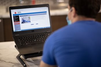 A person looks at information on their computer